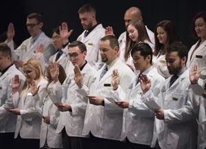 After receiving their white coats, Husson University Assistant Professor of Pharmacy Practice Kacie Guerrette, PharmD, will lead the students in reciting “The Oath of a Pharmacist.” As part of this oath, students pledge to adhere to the highest standards of ethics, integrity and professionalism as they provide service to the community.