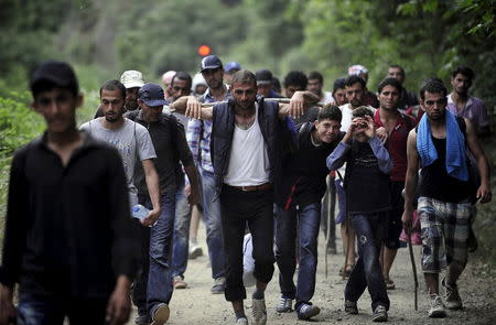 Migrants from Syria walk in Macedonia near the Greek border June 17, 2015. REUTERS/Ognen Teofilovski