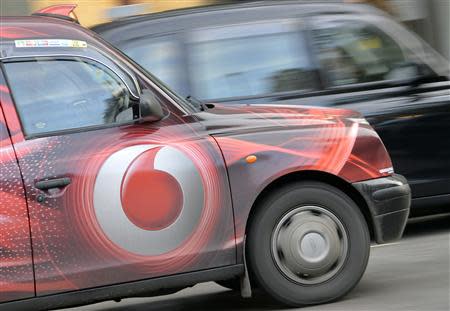 Vodafone branding is seen on the side of a London taxi in London November 12, 2013. REUTERS/Toby Melville