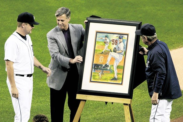 Detroit Tigers pitcher Todd Jones, left, is presented with a painting by General Manager David Dombrowski, center, and manager Jim Leyland as the Tigers honor Jones Saturday, Sept. 27, 2008 in Detroit. Jones announced his retirement Thursday.