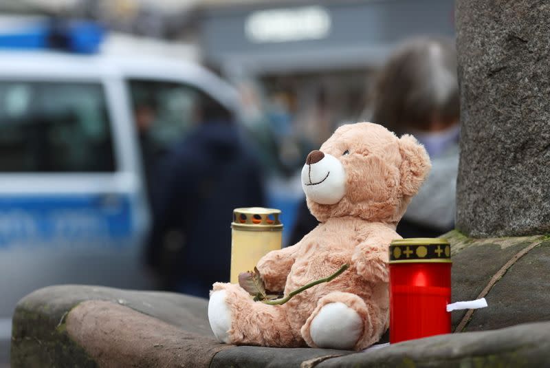 Candles and a teddy bear are pictured at the site where a car crashed into pedestrians in Trier