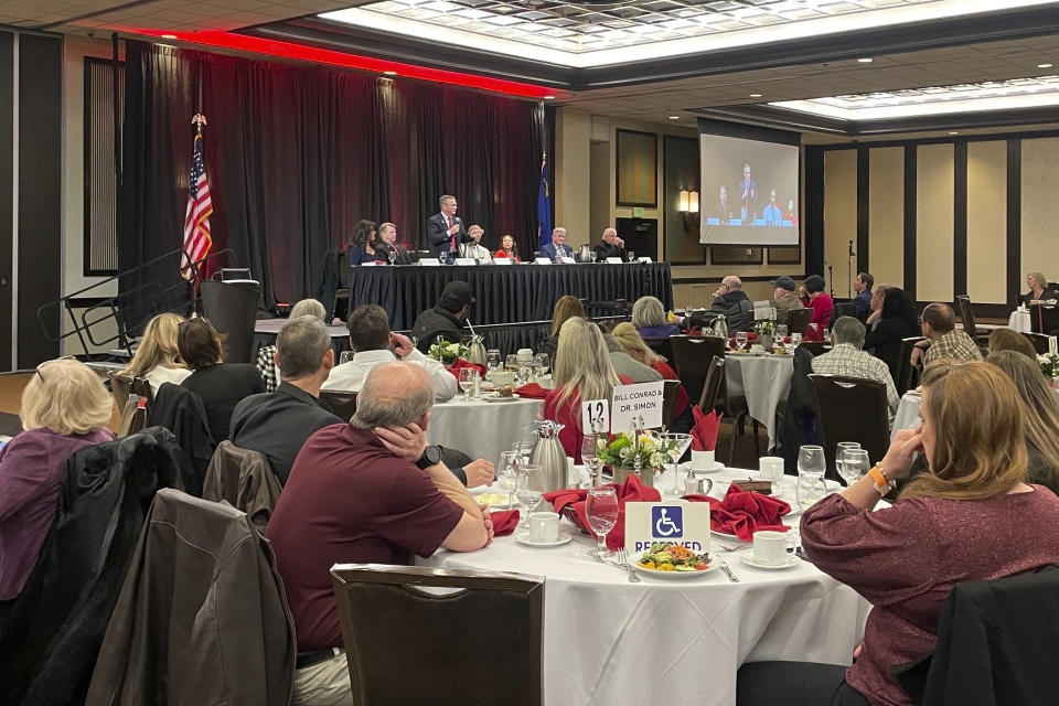 Retired U.S. Army lieutenant colonel and Senate candidate Bill Conrad, standing, speaks during a debate at the Atlantis Casino Resort ballroom in Reno, Nev., on Thursday, Jan. 18, 2024. The seven Republican Senate candidates often criticized former Army Capt. Sam Brown, the front-runner backed by National Senate Republicans, for not showing up. (AP Photo/Gabe Stern)