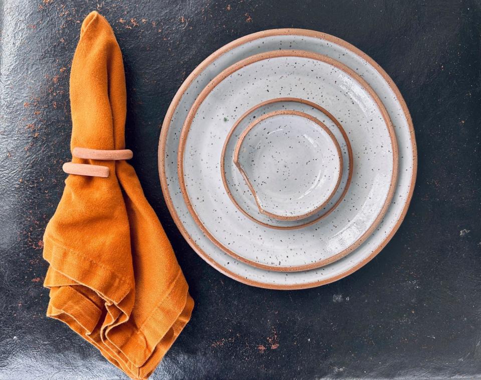 Dinnerware and napkin ring by Soil and Spoon.