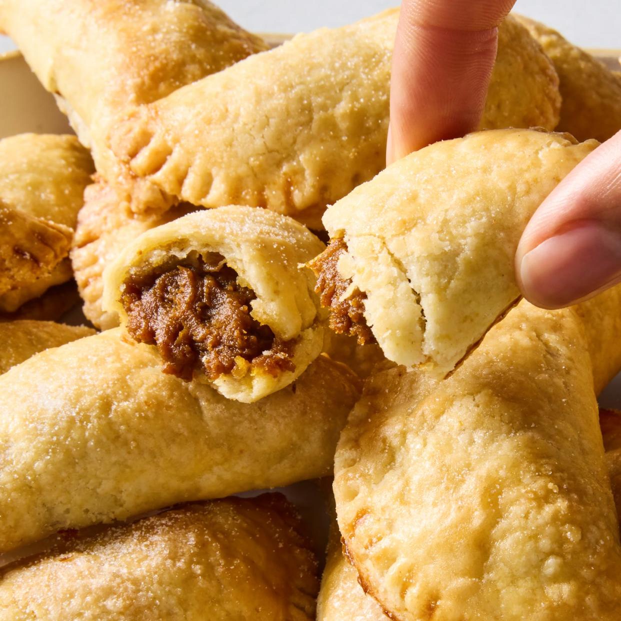 pumpkin empanadas piled on a platter