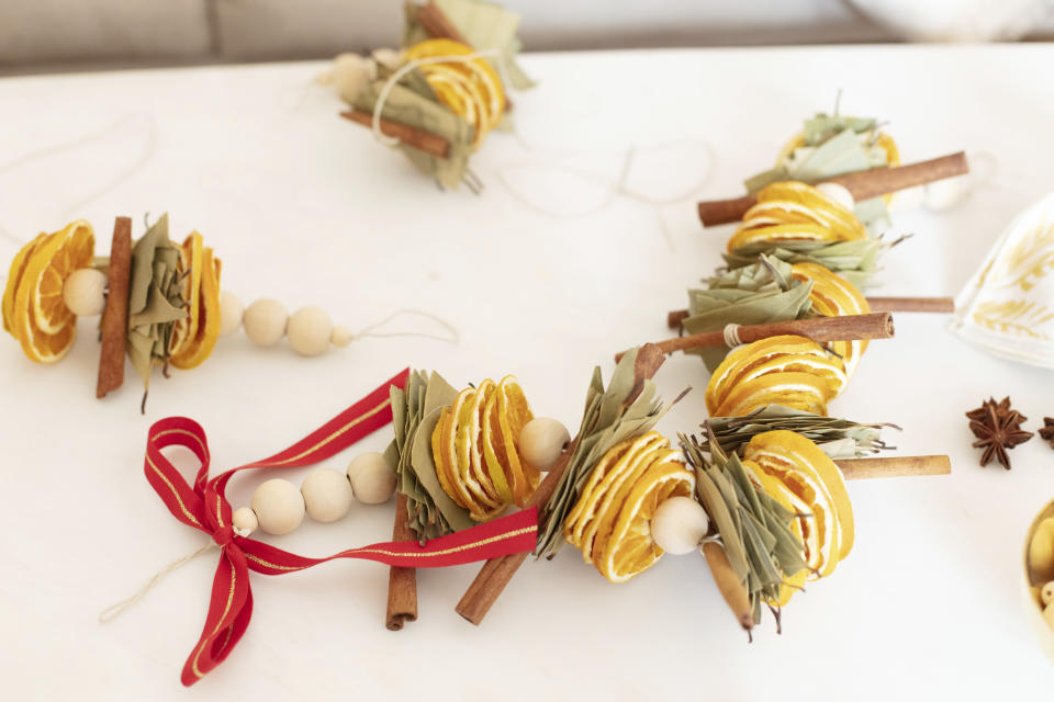 San Francisco Bay-area based Mariam Naficy, founder of online design marketplace Minted, has been making garlands this year out of various materials, including fragrant dried orange slices, like these shown here. "What I love about these is that they're stunning yet easy to make. You can display on a mantle, bookcase, or drape one on your dining table surrounded by tea candles for a simple, aromatic centerpiece." (Minted via AP)