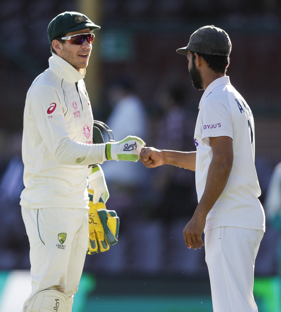 Rival captain's Australia's Tim Paine, left, and India's Ajinkya Rahane gesture to each other following play on the final day of the third cricket test between India and Australia at the Sydney Cricket Ground, Sydney, Australia, Monday, Jan. 11, 2021. The test ended in a draw and the series is at 1-1 all with one test to play. (AP Photo/Rick Rycroft)