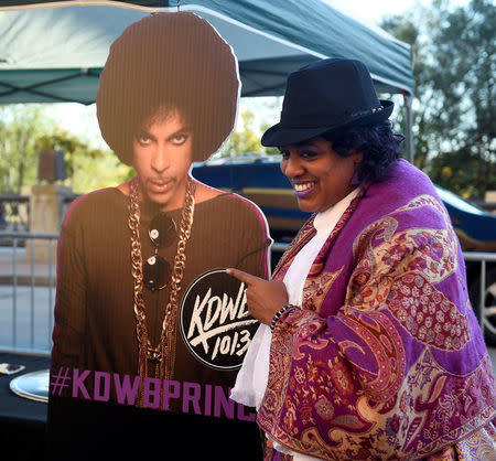 Darlene Blander of New York poses next to a life size cut-out of Prince as fans gather for an all-star concert tribute planned for in memory of Prince, six months after the influential pop star died, in St. Paul, Minnesota, U.S., October 13, 2016. REUTERS/Craig Lassig