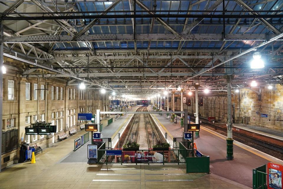 Empty platforms at Edinburgh Waverley train station (PA)