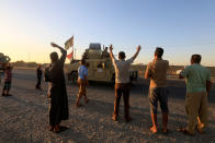 <p>People gather on the road as they welcome Iraqi security forces members, who continue to advance in military vehicles in Kirkuk, Iraq, Oct.17, 2017. (Photo: Alaa Al-Marjani/Reuters) </p>