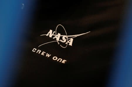 NASA commercial crew astronaut Michael Hopkins wears a NASA Crew One logo on his shirt as he trains inside a replica International Space Station (ISS) at the Johnson Space Center in Houston, Texas