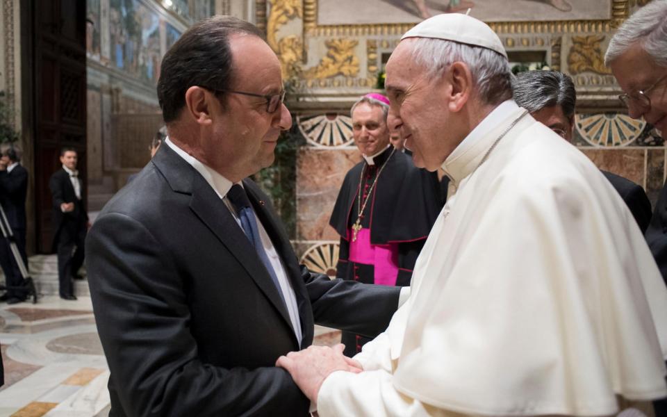 Pope Francis greets France's President Francois Hollande - Credit: AFP