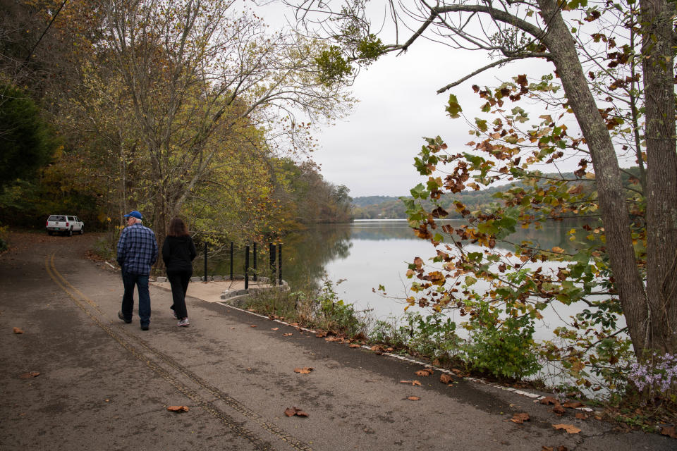 People walk along the waterfront at Radnor Lake State Park in Nashville, Tenn., Monday, Oct. 26, 2020.