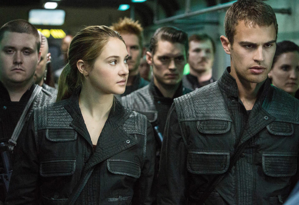 Shailene Woodley and Theo James waiting in a room with other people in "Divergent"
