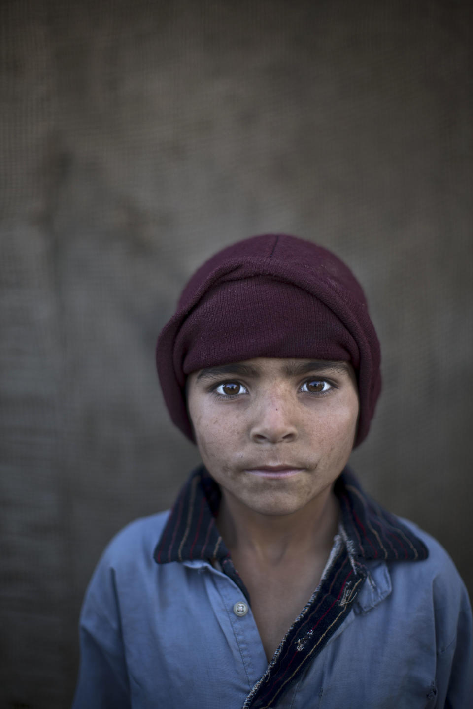 In this Sunday, Jan. 26, 2014 photo, Afghan refugee boy, Noorkhan Zahir, 6, poses for a picture, while playing with other children in a slum on the outskirts of Islamabad, Pakistan. For more than three decades, Pakistan has been home to one of the world’s largest refugee communities: hundreds of thousands of Afghans who have fled the repeated wars and fighting their country has undergone. Since the 2002 U.S.-led invasion of Afghanistan, some 3.8 million Afghans have returned to their home country, according to the U.N.’s refugee agency. (AP Photo/Muhammed Muheisen)