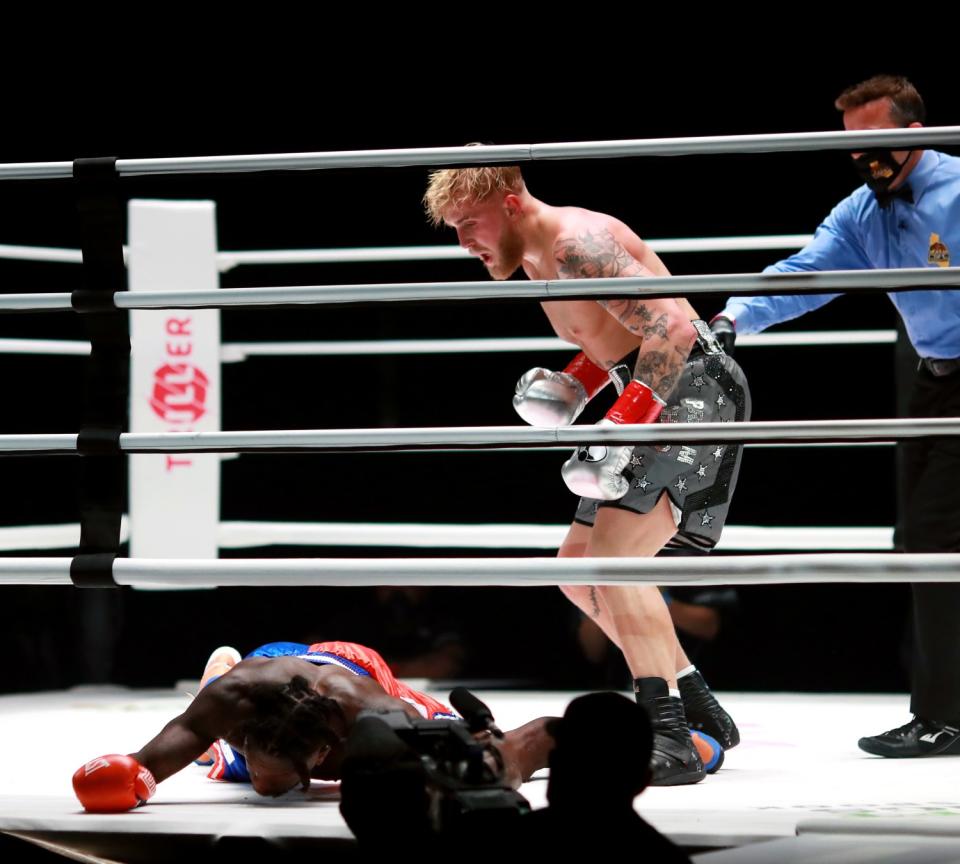 Jake Paul stands over Nate Robinson after knocking him out.