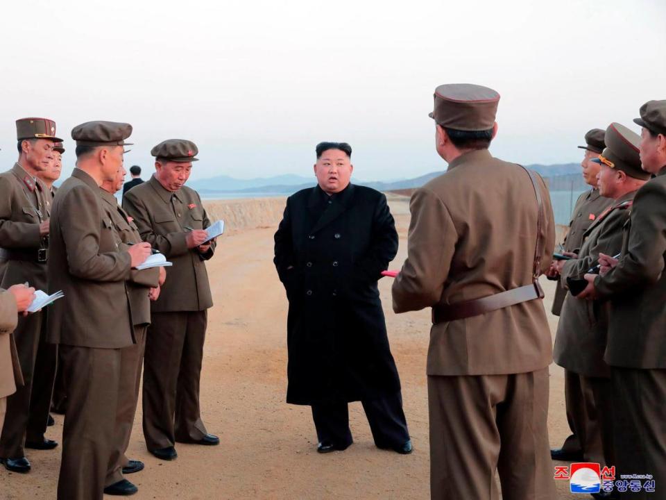 In a photo released the North Korean government, Kim Jong-un, (centre), inspects the testing of an unspecified weapon at the Academy of National Defence Science, in North Korea (AP)