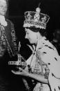 <p>She carried a large orb with a cross at the top while wearing a gigantic crown and a cape with tassels.</p>