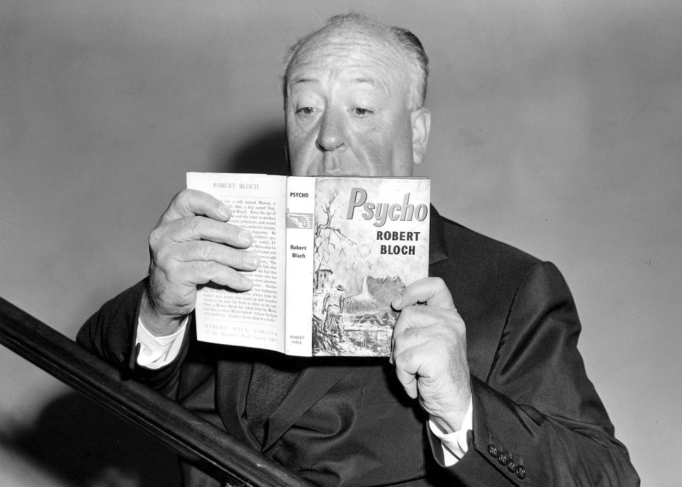 Alfred Hitchcock poses with the source novel while launching the film in 1960 (Harry Myers/REX/Shutterstock)