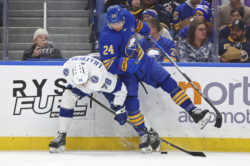 Tampa Bay Lightning defenseman Emil Martinsen Lilleberg (78) and Buffalo Sabres center Dylan Cozens (24) collide along the boards during the second period of an NHL hockey game Saturday, Jan. 20, 2024, in Buffalo, N.Y. (AP Photo/Jeffrey T. Barnes)