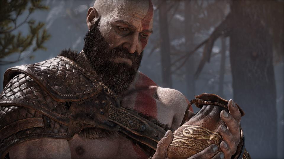 God of War Ragnarok's Kratos looking sadly at a pouch