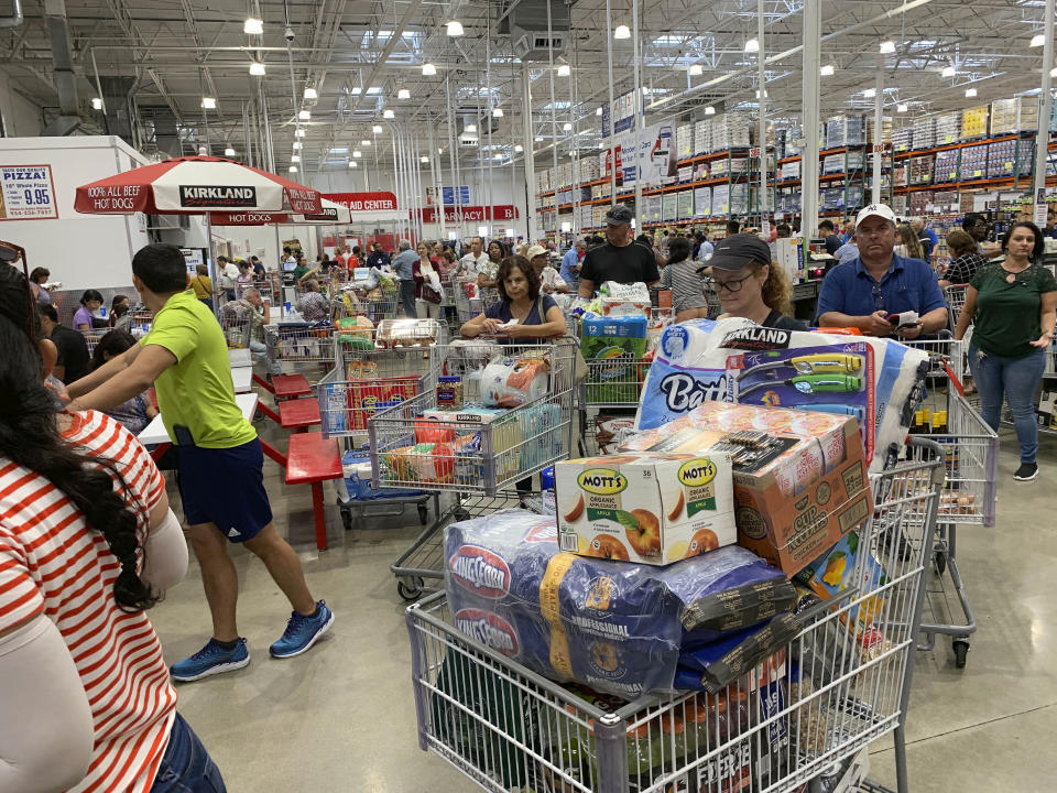 Shoppers wait in long lines at Costco, Thursday, Aug. 29, 2019, in Davie, Fla., as they stock up on supplies ahead of Hurricane Dorian. (AP Photo/Brynn Anderson)