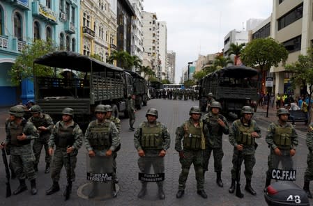 Soldiers stand guard to block a road and prevent demonstrators from marching against Ecuador's President Lenin Moreno's austerity measures, in Guayaquil