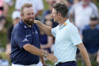 Justin Rose, of England, greets Shane Lowry, of Ireland, after the third round of the PGA Championship golf tournament at the Valhalla Golf Club, Saturday, May 18, 2024, in Louisville, Ky. (AP Photo/Jeff Roberson)
