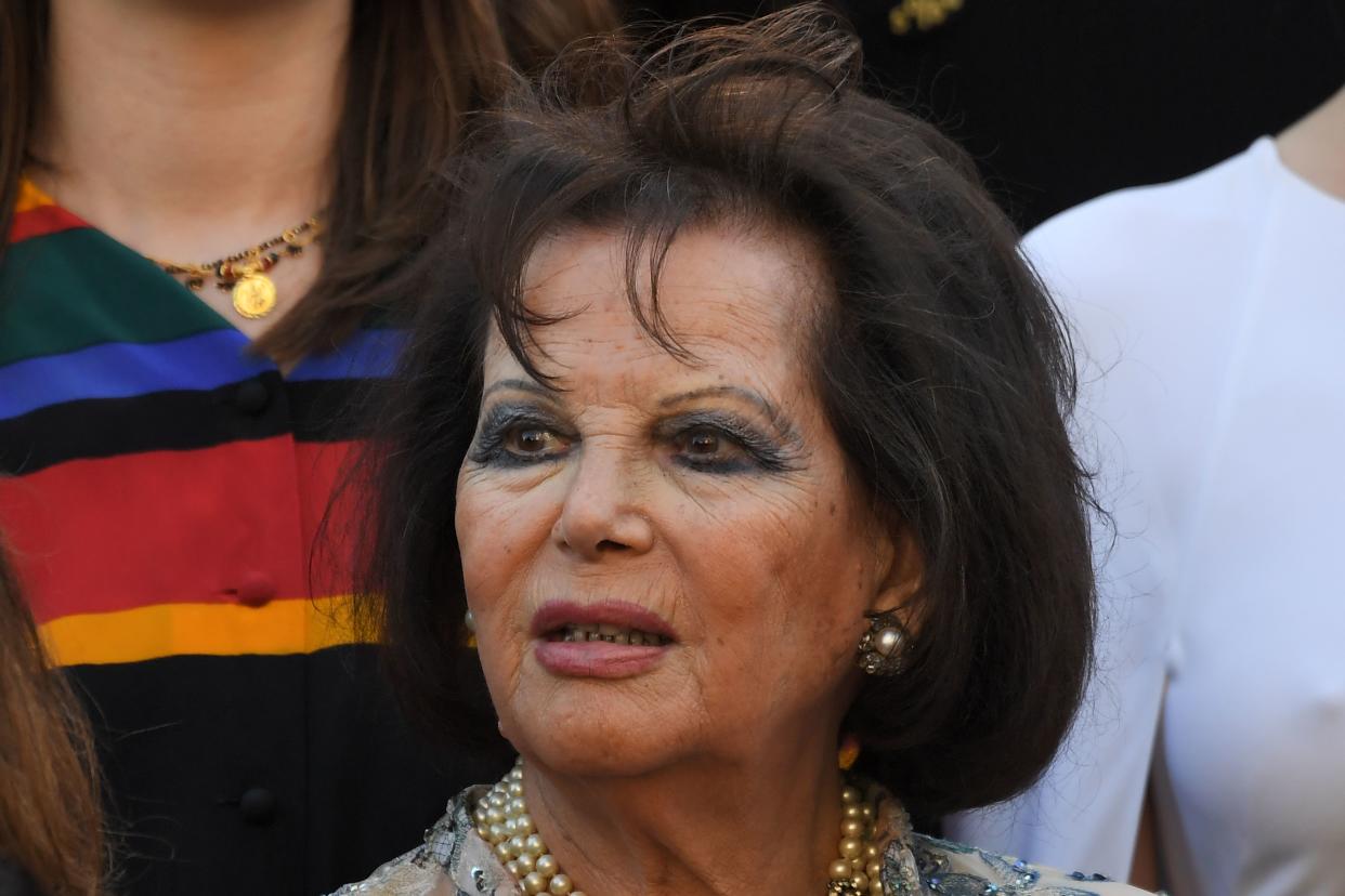 Italian-Tunisian actress Claudia Cardinale listens to the Jury head read a statement on the steps of the red carpet in protest of the lack of female filmmakers honored throughout the history of the festival at the screening of 