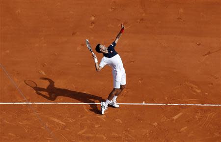 Novak Djokovic of Serbia serves to Albert Montanes of Spain during the Monte Carlo Masters in Monaco April 15, 2014. REUTERS/Eric Gaillard