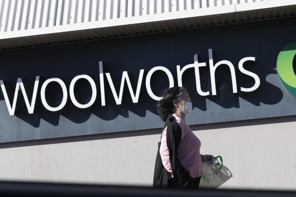 SYDNEY, AUSTRALIA - AUGUST 17: A woman in a surgical mask walks past the entrance to the Woolworths Metro supermarket in North Strathfield on August 17, 2020 in Sydney, Australia. New South Wales remains on high alert as new COVID-19 cases continue to be diagnosed. Customers of the Supermarket are being urged to watch for symptoms after a person who has tested positive for COVID-19 case visited the store over the weekend. The state recorded seven new cases of COVID-19 in the last 24 hours with six locally-acquired and one in hotel quarantine. (Photo by Brook Mitchell/Getty Images)