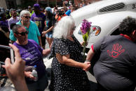 <p>Susan Bro (C), mother of Heather Heyer, arrives at a makeshift memorial for her daughter Heather who was killed one year ago during a deadly clash, August 12, 2018 in Charlottesville, Virginia. Charlottesville has been declared in a state of emergency by Virginia Gov. Ralph Northam as the city braces for the one year anniversary of the deadly clash between white supremacist forces and counter protesters over the potential removal of Confederate statues of Robert E. Lee and Jackson. A ‘Unite the Right’ rally featuring some of the same groups is planned for today in Washington, DC. (Photo: Win McNamee/Getty Images) </p>