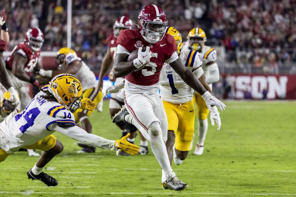 Alabama running back Roydell Williams (5) runs the ball past LSU safety Andre' Sam (14) for a touchdown during the second half of an NCAA college football game, Saturday, Nov. 4, 2023, in Tuscaloosa, Ala. (AP Photo/Vasha Hunt)