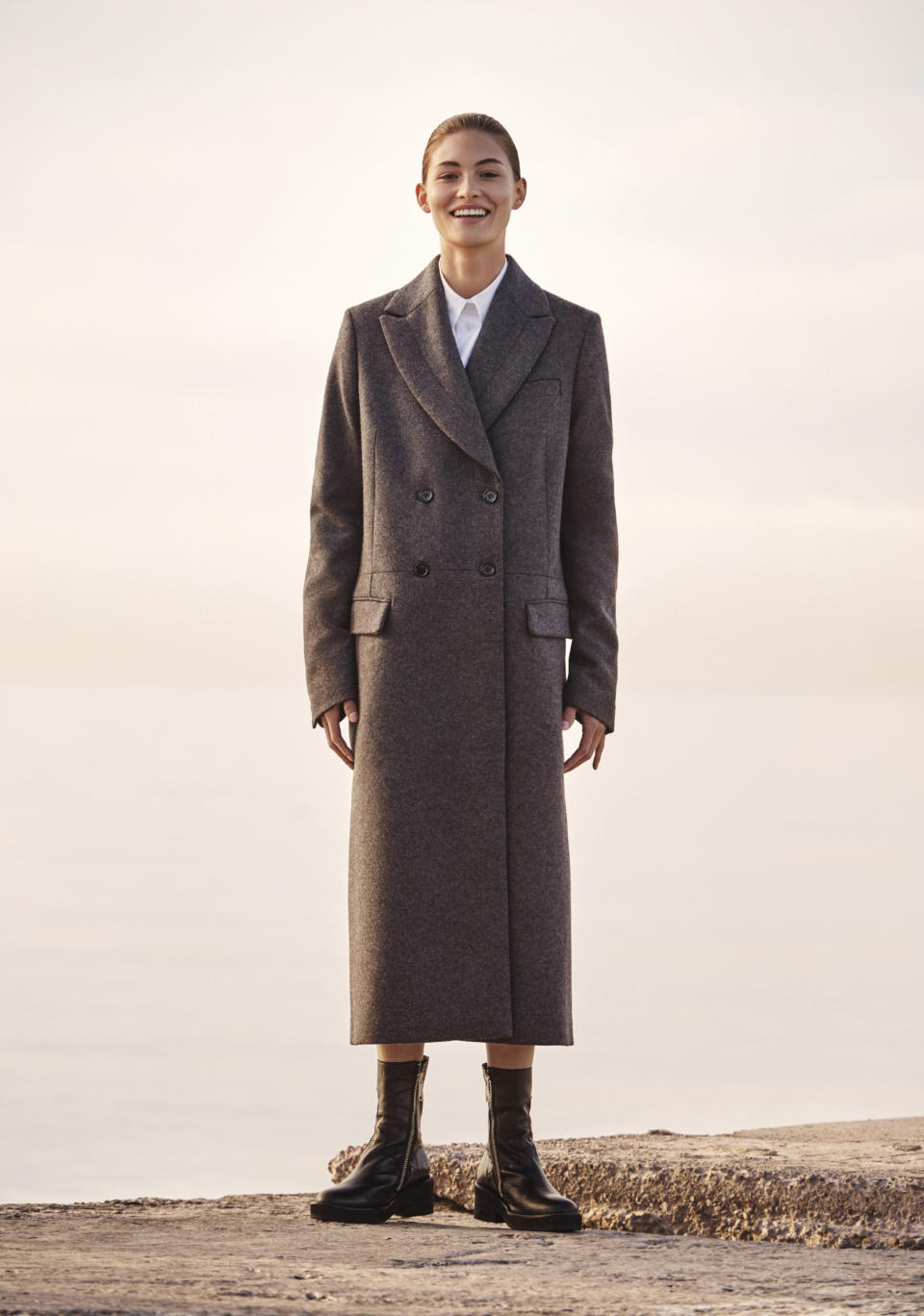 Model Grace Elizabeth in a long double-breasted coat made of melange wool from the H&M Studio AW17 collection, photographed by Christian MacDonald, styled by Ludivine Poiblanc, in Mallorca, Spain. (Photo: Courtesy of H&M)