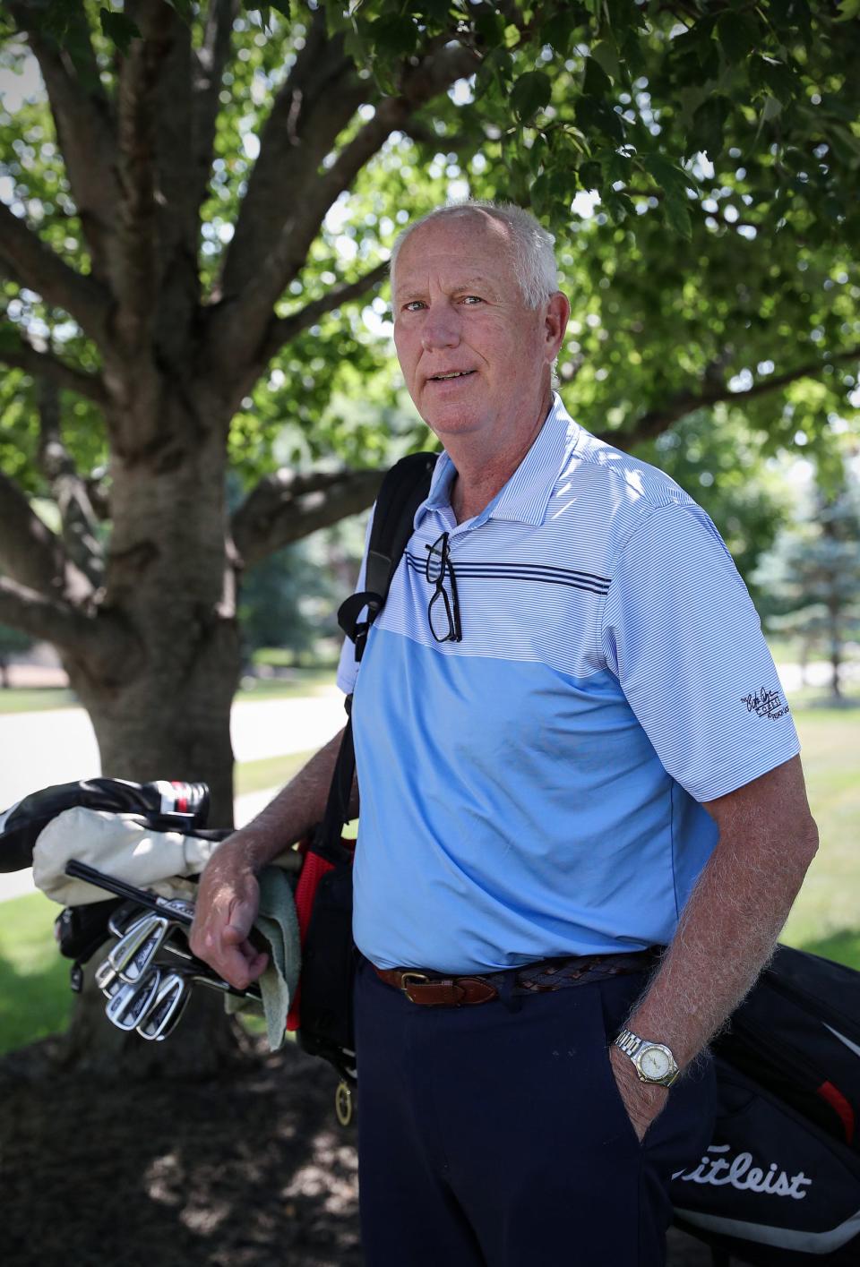 Former Indiana University basketball standout Ted Kitchel stands with golf clubs in front of his Greenwood home Thursday, August 5, 2021. Kitchel lives with Parkinson's disease. For the second year, his family will host the Ted Kitchel Golf Outing for Parkinson's disease at Valle Vista Golf Club in Greenwood on August 23, 2021. Money raised will be donated to the IU Health Neuroscience Center for Parkinson's disease research. 