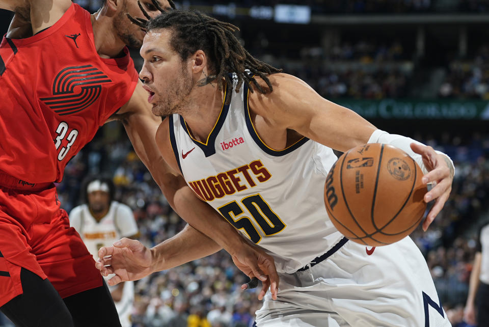 Denver Nuggets forward Aaron Gordon, right, drives past Portland Trail Blazers forward Toumani Camara, left, in the second half of an NBA basketball game Sunday, Feb. 4, 2024, in Denver. (AP Photo/David Zalubowski)