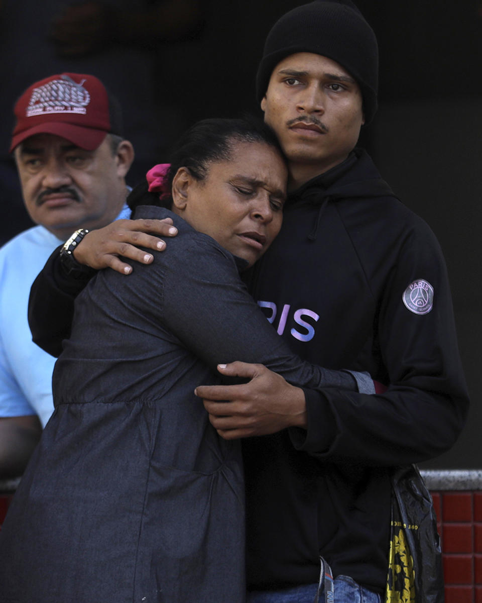 People wait outside the Getulio Vargas Hospital for the arrival of people who were injured or killed during a police raid in the Vila Cruziero favela of Rio de Janeiro, Brazil, Tuesday, May 24, 2022. Police in Rio de Janeiro raided the Vila Cruzeiro favela before dawn Tuesday in an operation that prompted a fierce firefight and state officials said at least 10 people died. (AP Photo/Bruna Prado)