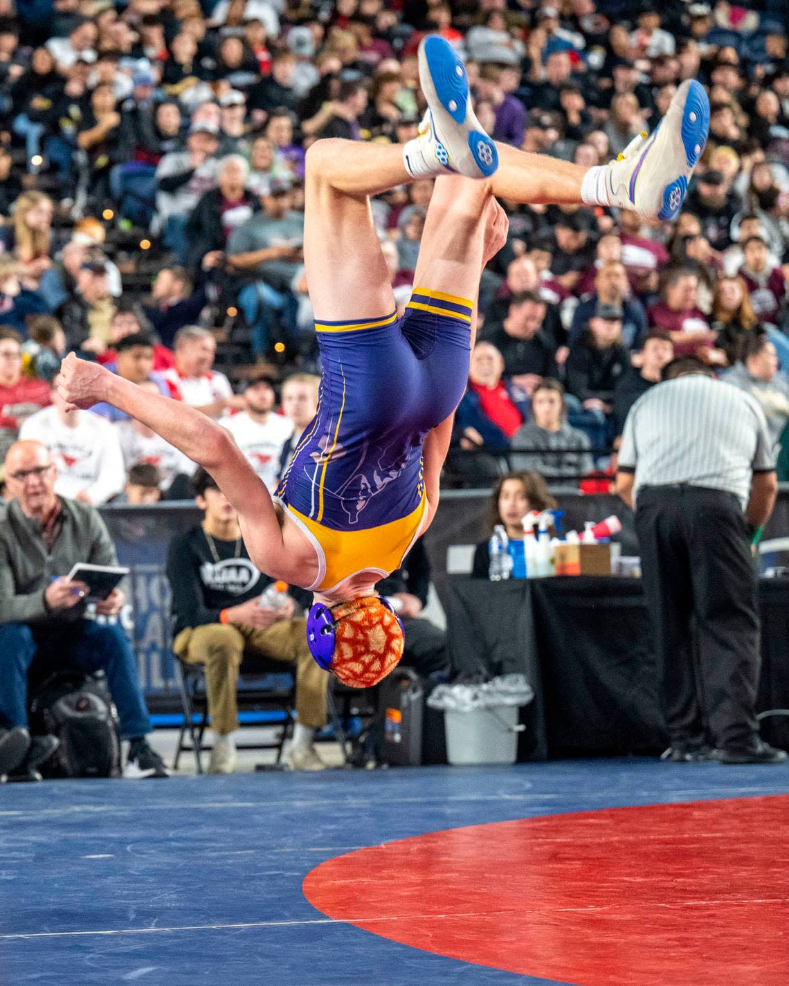 Sumner’s Cody Miller celebrates with a backflip after beating Glacier Peak’s Gil Mossburg, 6-3, in a Class 4A 145-pound championship match at Mat Classic XXXIV on Saturday, Feb. 18, 2023, at the Tacoma Dome in Tacoma, Wash.