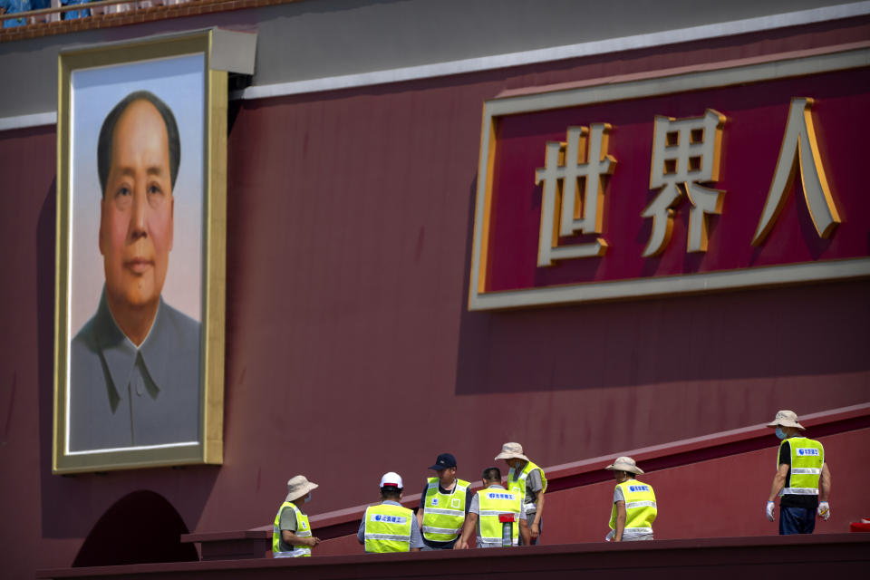 Workers prepare a raised seating area near the large portrait of Chinese leader Mao Zedong on Tiananmen Gate near Tiananmen Square in Beijing, Tuesday, June 22, 2021. Chinese authorities have closed Beijing's central Tiananmen Square to the public, eight days ahead of a major celebration being planned to mark the 100th anniversary of the founding of the ruling Communist Party. (AP Photo/Mark Schiefelbein)