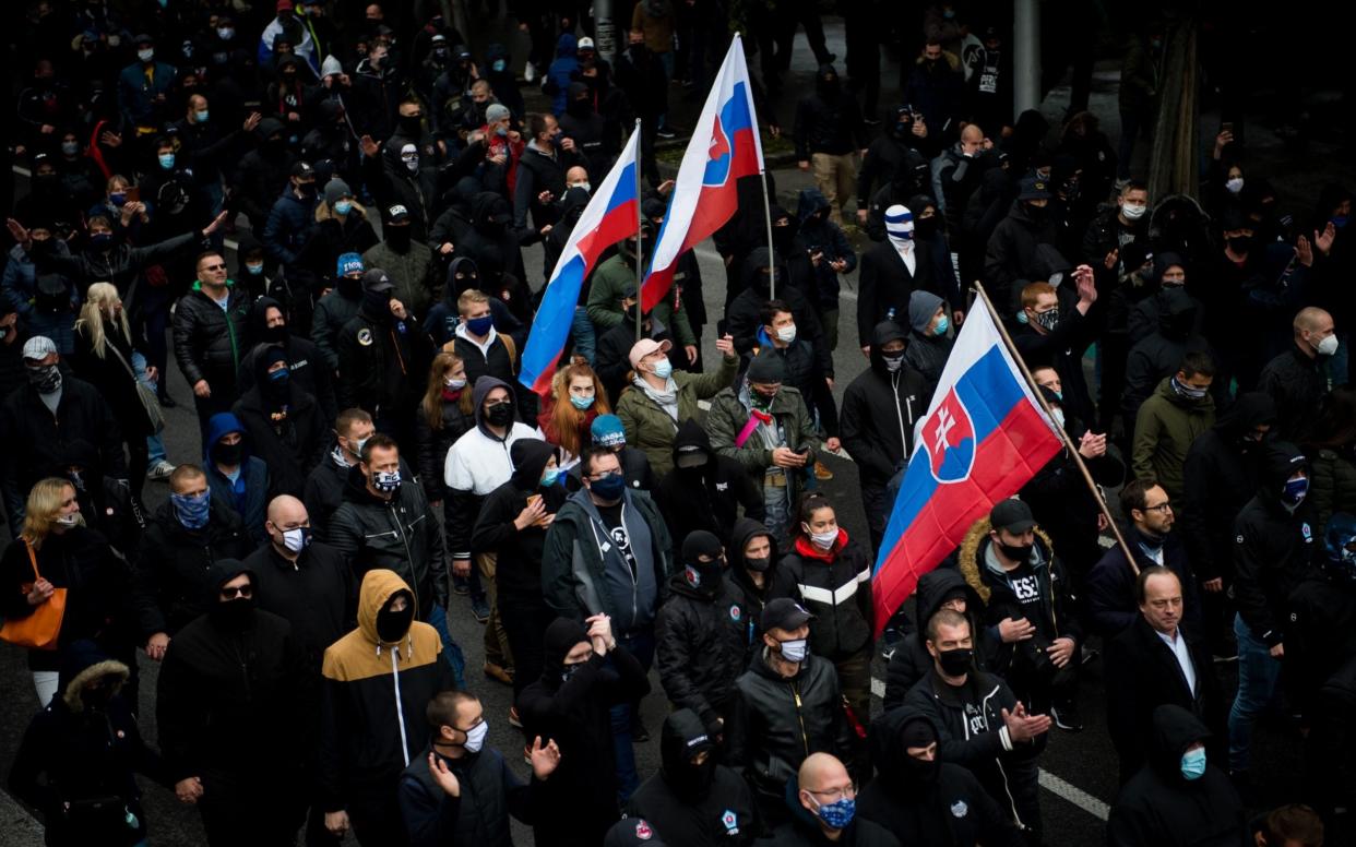 Hundreds of football hooligans and far-right supporters protest the government's precautionary measures - VLADIMIR SIMICEK/AFP via Getty Images