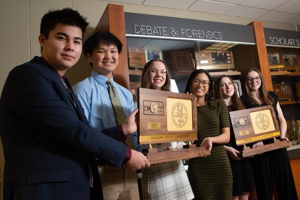 Washburn Rural's 2021 state debate champions, starting with the four-speaker team from left, Zach Willingham, Jiyoon Park, Sonya Doubledee and Donna Jalosjos join two-speaker team Karissa Kromminga and Lauren Reed, holding their titles earlier this year.