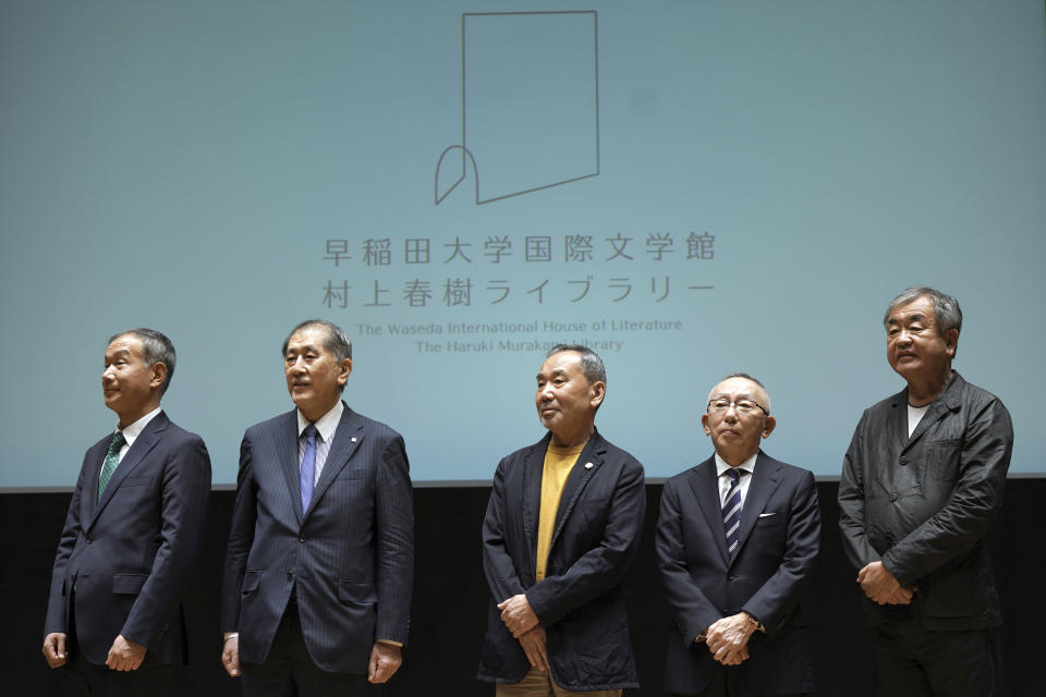 Japanese novelist Haruki Murakami, center, Chairman, President and CEO, UNIQLO CO., LTD. Tadashi Yanai, second right, and Kengo Kuma, right, the architect behind the Olympic stadium, and other university officials pose for media during a press conference on the university's new international house of literature as known as The Haruki Murakami Library at the Waseda University Wednesday, Sept. 22, 2021, in Tokyo. (AP Photo/Eugene Hoshiko)