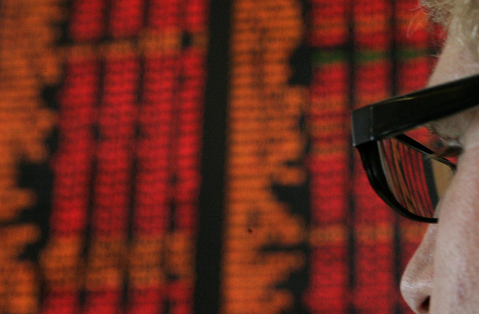 A man looks at the indicator board at the Australian Securities Exchange.