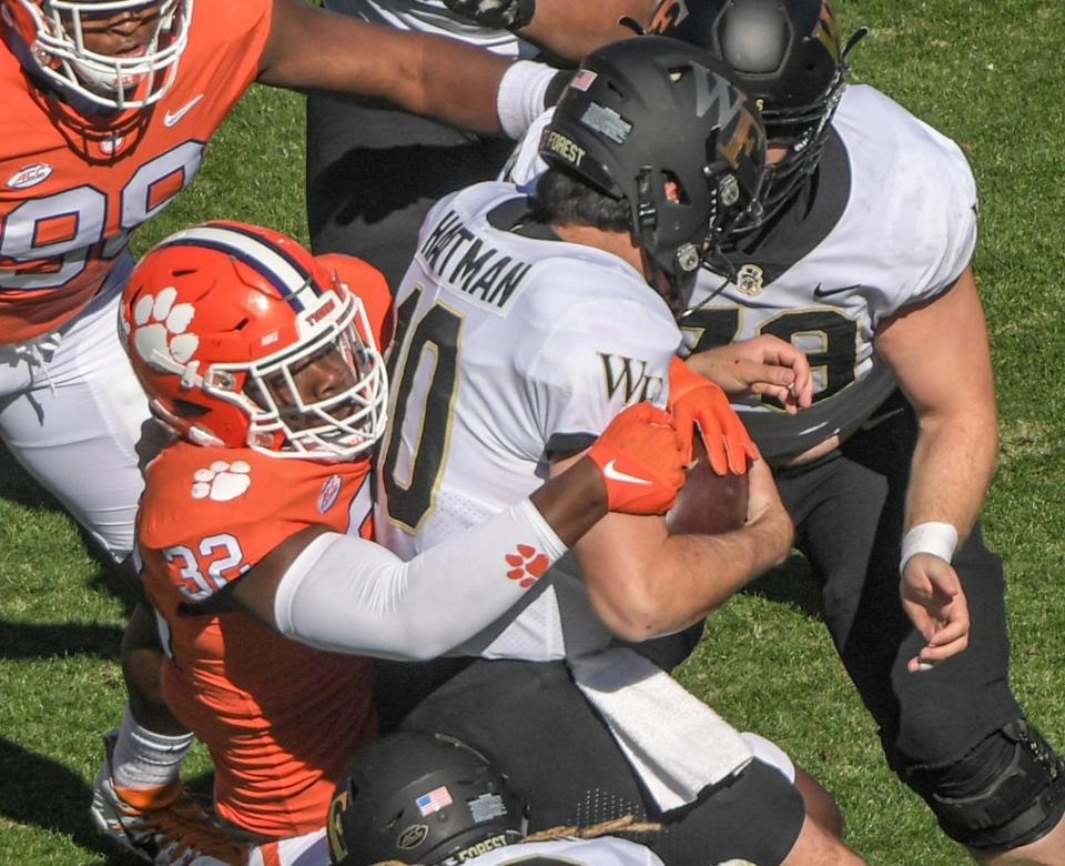 Clemson defensive tackle Etinosa Reuben (32) sacks Wake Forest quarterback Sam Hartman (10) during the first quarter at Memorial Stadium in Clemson, South Carolina Saturday, November 20, 2021.