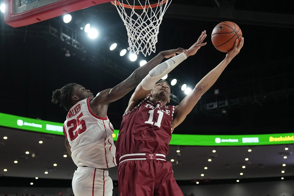 Temple's Nick Jourdain (11) goes up for a shot as Houston's Jarace Walker (25) defends during the second half of an NCAA college basketball game Sunday, Jan. 22, 2023, in Houston. Temple won 56-55. (AP Photo/David J. Phillip)