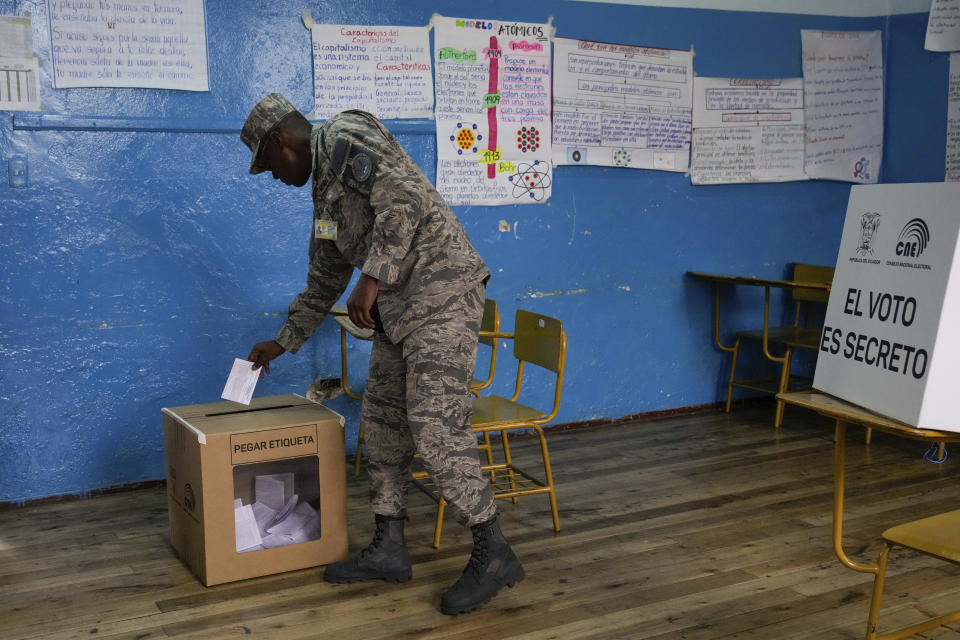 An Air Force soldier votes in a referendum proposed by President Daniel Noboa to endorse new security measures aimed at cracking down on criminal gangs fueling escalating violence, in Quito, Ecuador, Sunday, April 21, 2024. (AP Photo/Dolores Ochoa)