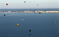 IN FLIGHT, UNITED KINGDOM - APRIL 07: Hot air balloons which departed from Lydden Hill race circuit near Canterbury take part in a mass crossing of the English Channel on April 7, 2011 near Dover, England. 51 balloonists of various nationalities from across Europe took off from Kent making for Calais, France at about 7am. It is the first time a Guinness World Record bid has been made for "the largest group of hot air balloons to make the Channel crossing". (Photo by Oli Scarff/Getty Images)