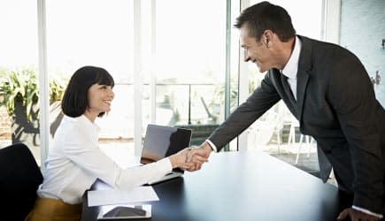 Businesswoman welcoming man to meeting