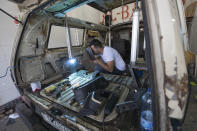 A welder converts a van into a food truck, at a workshop in the West Bank city of Ramallah, Tuesday, Sept. 22, 2020. With dine-in restaurants mostly closed due to health restrictions, food trucks have allowed Palestinian entrepreneurial businessmen to find a way to keep working. (AP Photo/Nasser Nasser)