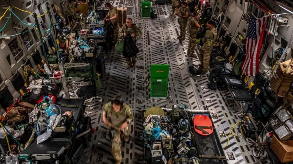 U.S. Air Force airmen from the 379th Expeditionary Aeromedical Evacuation Squadron prepare their equipment on a C-17 Globemaster III over the skies of U.S. Central Command, Aug. 26, 2021. (Courtesy of Katie Lunning)