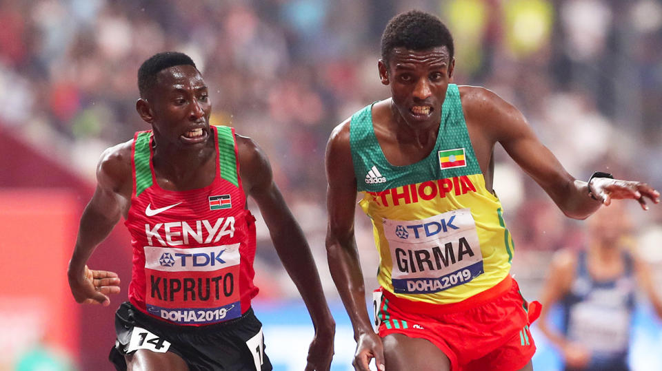 Conseslus Kipruto of Kenya racing Lamecha Girma of Ethiopia.